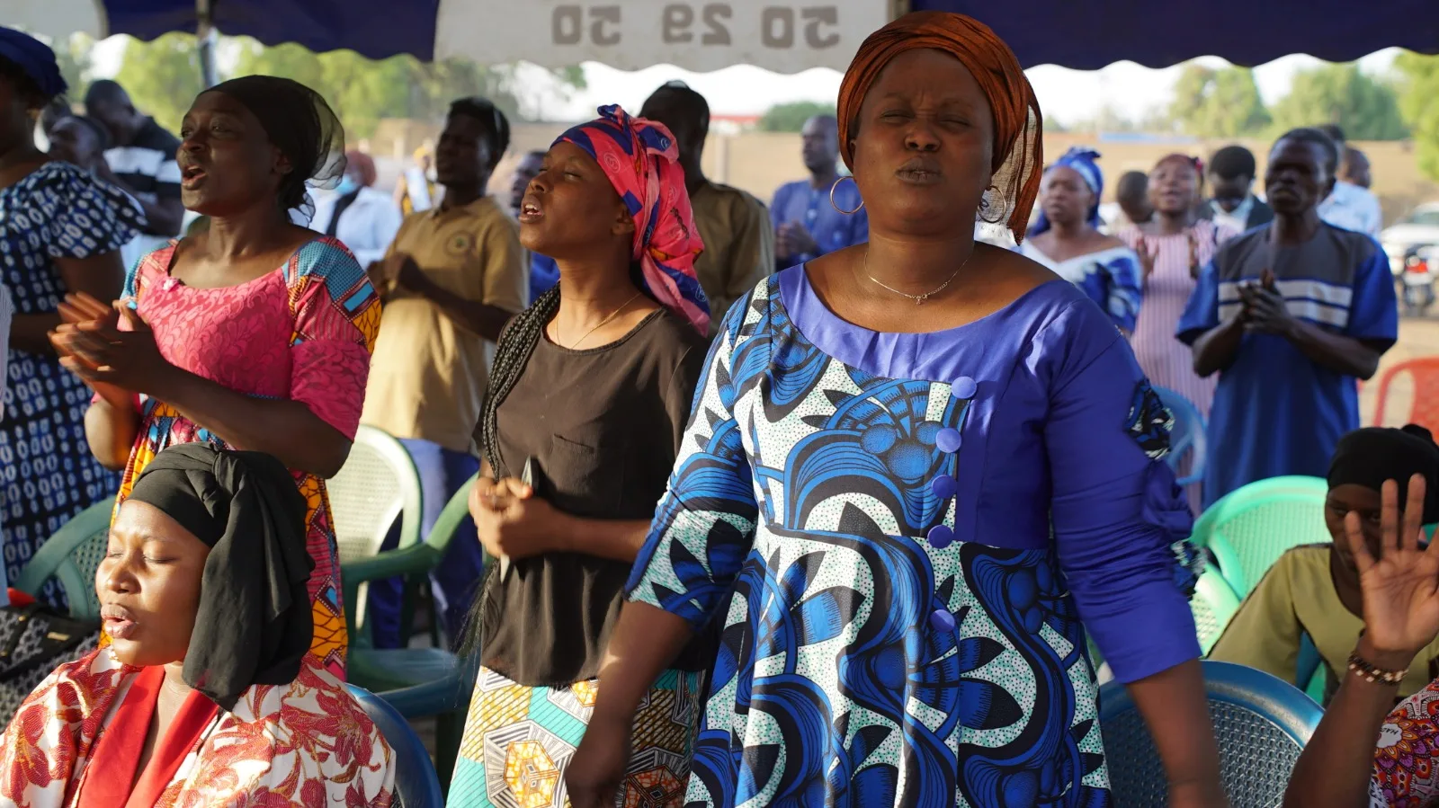 Worshippers singing at a Favor gathering